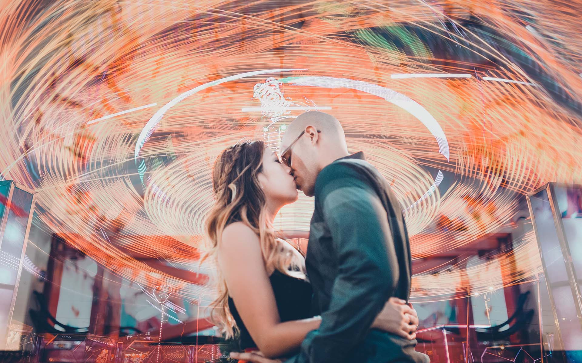 Orange County Fair engagement session with slow shutter effect creating light painting rides