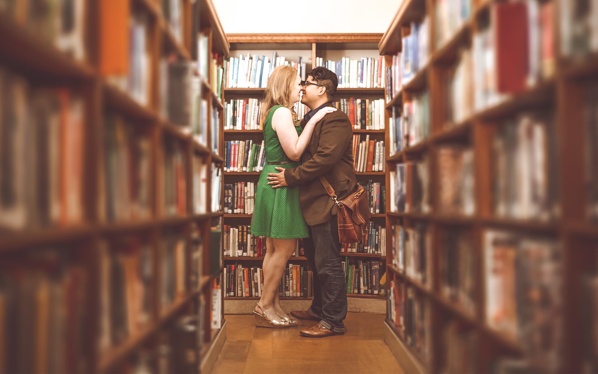 engagement photography between bookcases in los angeles library