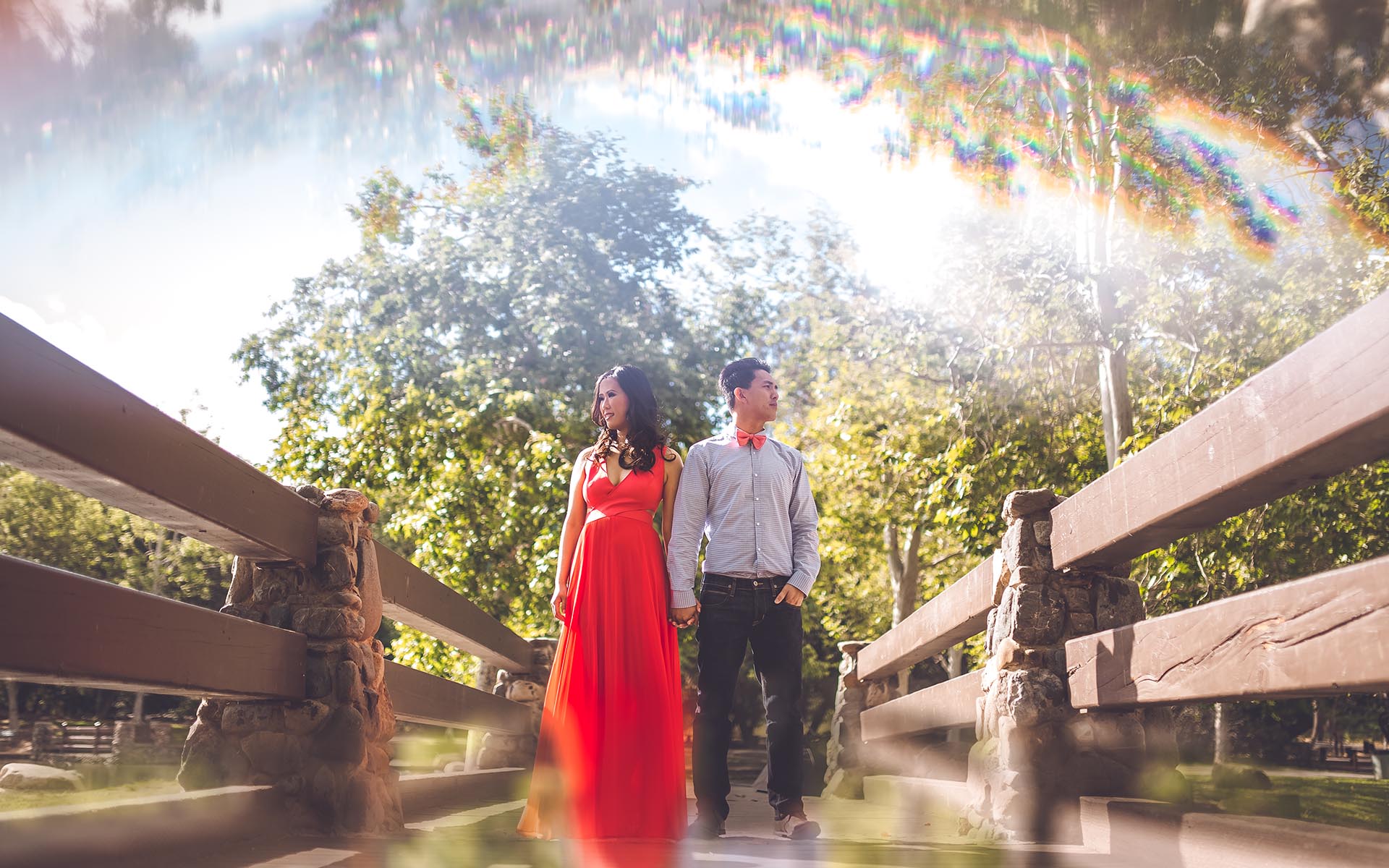 couple standing at bridge engagement session in orange county irvine park